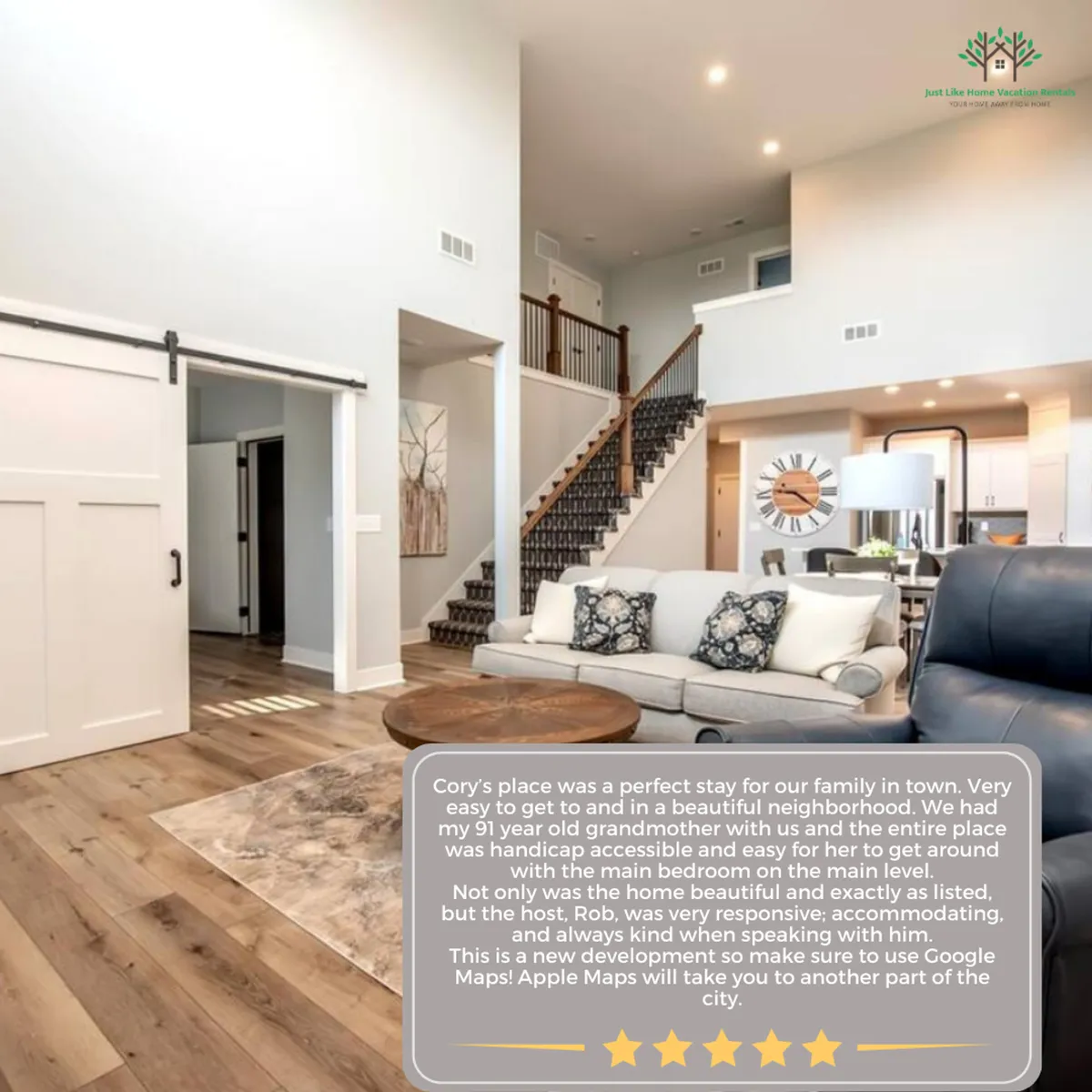 A spacious interior with a visible staircase, open sofa set, and broad walkways. The area feels uncluttered, airy, and easy to navigate. Decorative wall art and a large clock add warmth without compromising space.